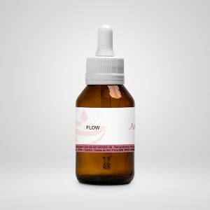 Embalagem de vidro em frasco marrom. Nela há uma etiqueta branca com detalhes em rosa metálico e informações do produto. A tampa é branca e no estilo conta gotas.